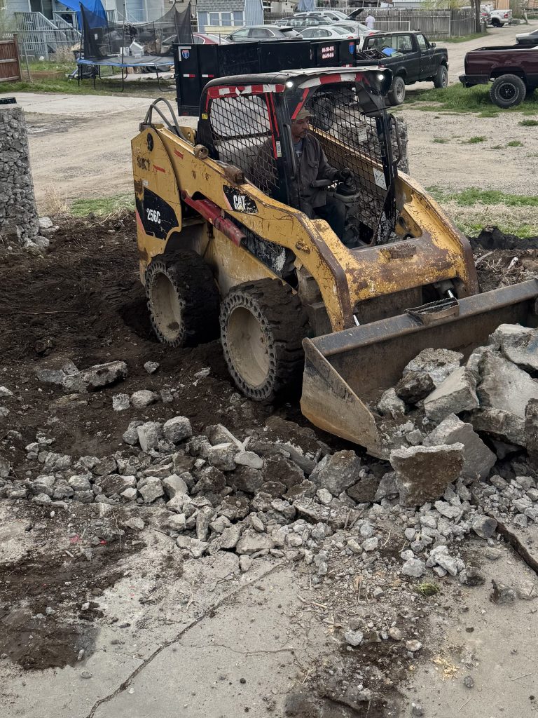 Skid Steer Service in Billings. Dirt & gravel spreading, driveway repair & maintenance, land clearing & site preparation, brush & vegetation removal, grading & leveling, backfilling & excavation support, trenching assistance, small demolition projects (sheds, concrete pads, etc.), post hole digging (for fencing, signposts, etc.), material hauling & placement (rock, soil, mulch).