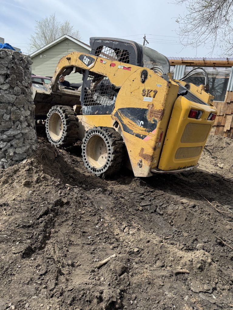 Skid Steer Service in Billings. Dirt & gravel spreading, driveway repair & maintenance, land clearing & site preparation, brush & vegetation removal, grading & leveling, backfilling & excavation support, trenching assistance, small demolition projects (sheds, concrete pads, etc.), post hole digging (for fencing, signposts, etc.), material hauling & placement (rock, soil, mulch).